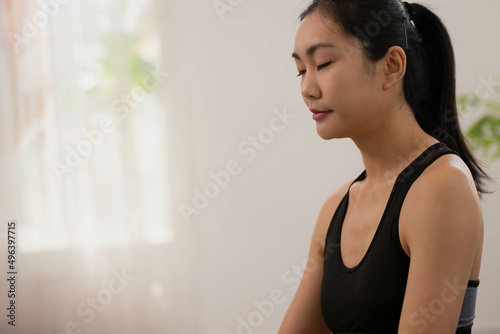 After waking up at home, a woman does morning yoga, sitting in Easy position, Sukhasana posture, and meditating. Free Download After waking up at home, a woman does morning yoga, sitting in Easy position, Sukhasana posture, and meditating. - GFXLoad