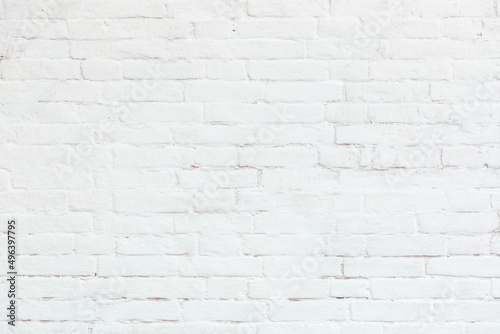 White brick wall with cracks  cement  stucco. Can be used as a poster or background for design. 