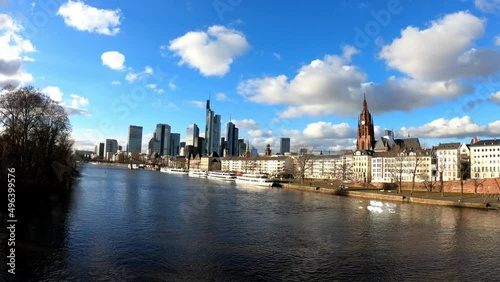 PAN SLOW - Business corporate downtown bank district with high tall skyscraper buildings, Saint Bartholomeus's Cathedral, and Eiserner Steg bridge over the Main River in Frankfurt am Main, Germany. photo