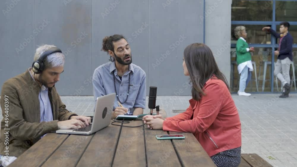 Group of people recording radio podcast together - Young friends talking during live stream session outdoor Group of people recording radio podcast together - Young friends talking during live stream session outdoor