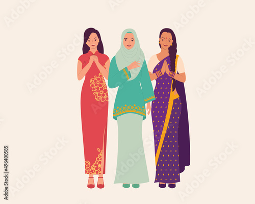 Three Women Dressed In Beautiful Traditional Clothes Greeting. photo