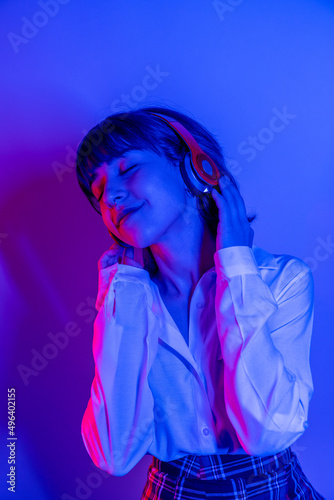 Cheerful female high school student listening to music 