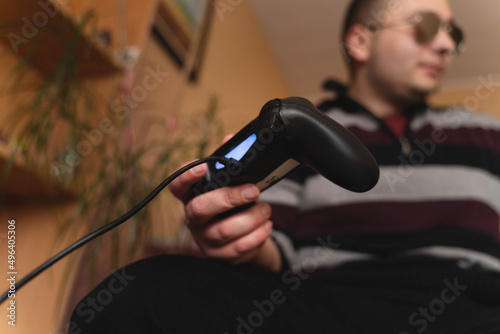 A man holding a controller in his hands close up