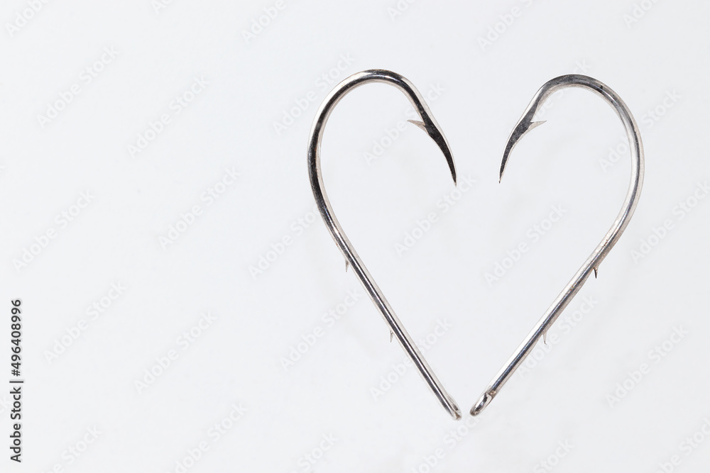A heart of Fishing hooks isolated on white background. Love fishing concept .