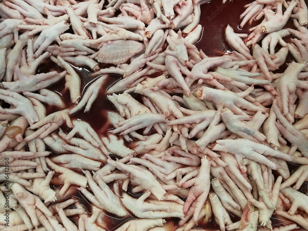 Many raw chicken feet are placed in blood and sold in the mall. Many raw chicken feet are placed in blood and sold in the mall.
