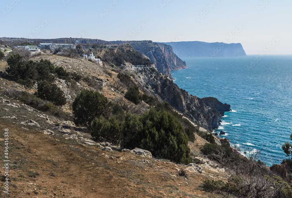 View of Crimean rugged rocky shore with Saint George Monastery in spring. Sevastopol, Crimea