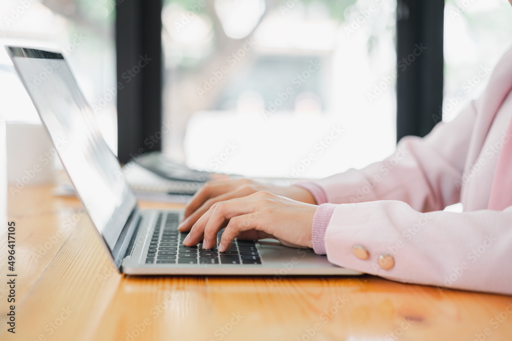 Fototapeta premium Cropped shot of businesswoman working,typing on tablet computer. Selective focus,Soft focus.