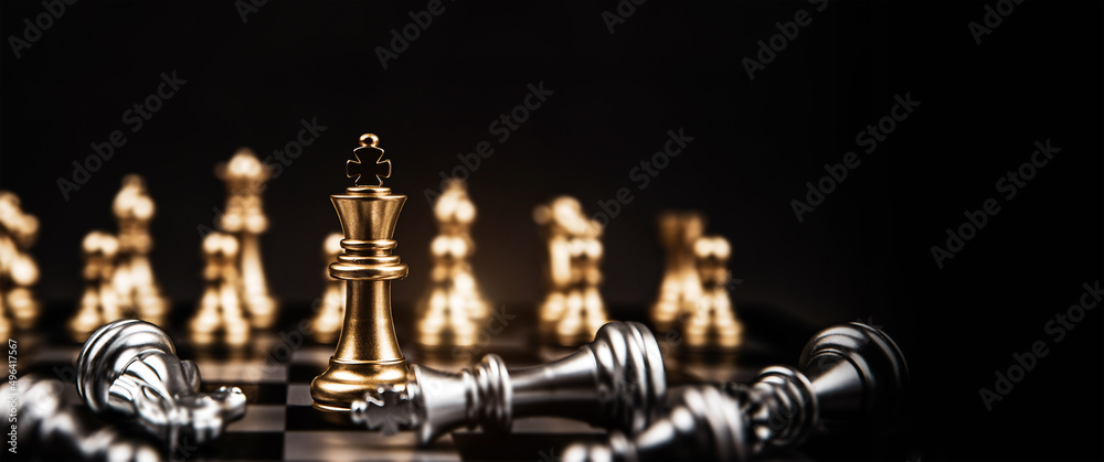 Close-up king chess standing on falling chess concepts of wining to challenge or battle fighting of business team and leadership strategy and organization risk management or team player. Close-up king chess standing on falling chess concepts of wining to challenge or battle fighting of business team and leadership strategy and organization risk management or team player.