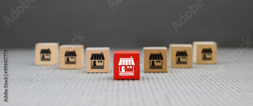 Fotografija Franchise or franchising, Cube wooden toy block stack pyramid with franchises business store icon for growth and products services or grow expand or bank loan for branch expansion