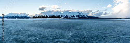 Panoramic view of a winter scene in northern Canada during January with snow capped mountains.  photo