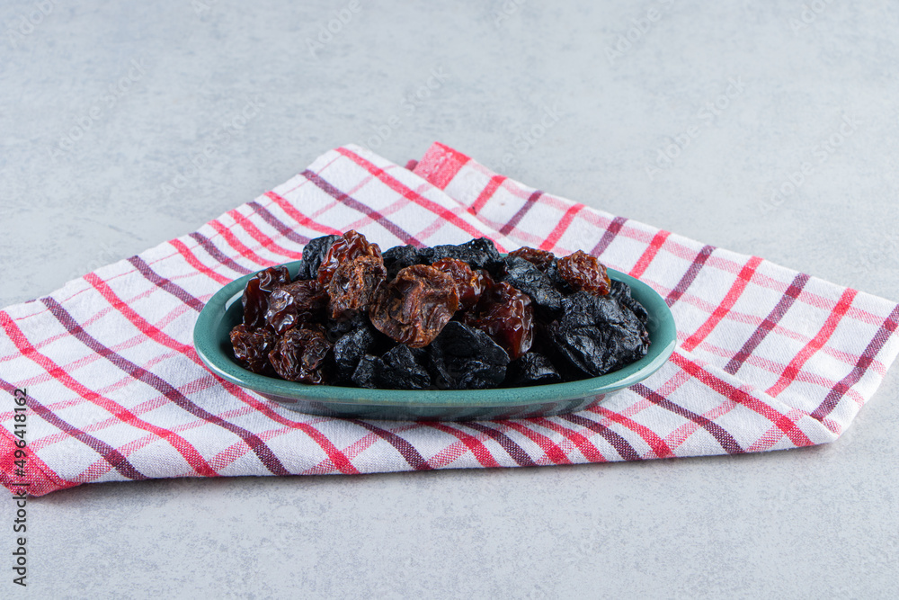 Dry black plums and dates in a blue platter, Ajwa dates. Dried date