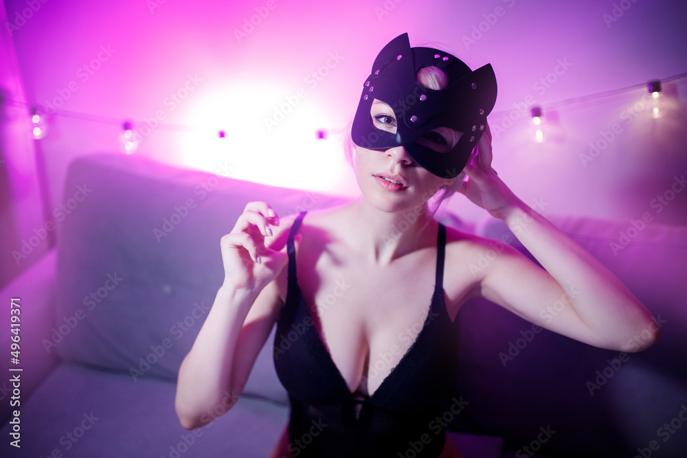 Happy woman working as internet web cam model in face mask cat, pink color  foto de Stock | Adobe Stock
