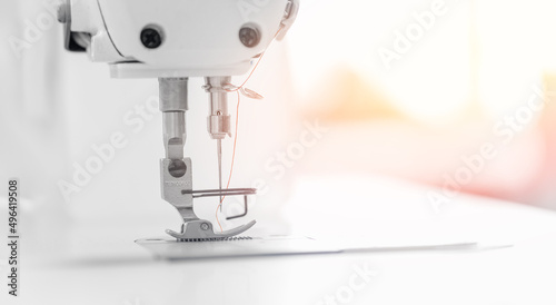 Closeup sewing machine for pocket, background white color sunlight. Concept Interior of garment factory