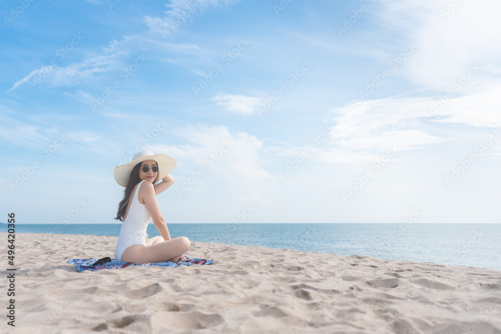 Vacation on the beach, Young woman relaxing on the beach in summer Vacation on the beach, Young woman relaxing on the beach in summer