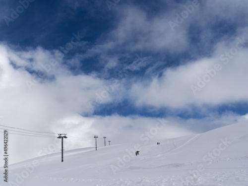 Image of a snow covered mountain plateau. Tourists walk and take pictures on a mountain plateau. © PhotoBetulo