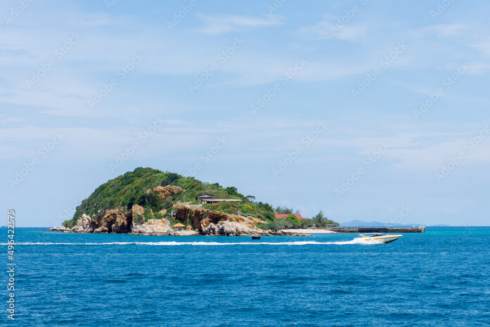 Island with speedboat is moving in the blue sea. Koh Larn, Pattaya, Thailand.