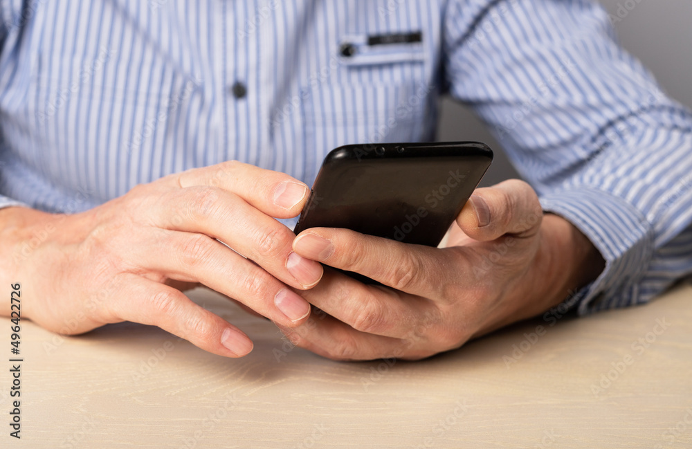 Man hands closeup with phone. Using smartphone for work, social communication, education,online shopping, information search, relax. High quality photo Man hands closeup with phone. Using smartphone for work, social communication, education,online shopping, information search, relax. High quality photo