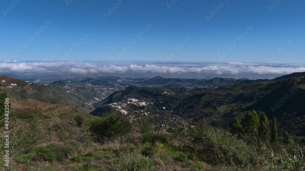 Beautiful panoramic view over the northeast of island Gran Canaria, Canary Islands, Spain on sunny day with mountains covered by green vegetation.