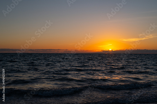 Sunset at sea landscape. Dramatic sunset sky with clouds. Dramatic sunset over the sea. Beautiful sunrise or sunset at sea. © Volodymyr