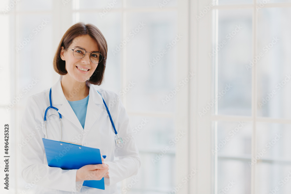 Good looking female expert creats medical prescription, writes down information in clipboard, thinks about good advice for patient Good looking female expert creats medical prescription, writes down information in clipboard, thinks about good advice for patient