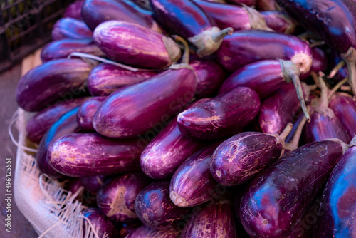 Wallpaper Mural Eggplants at a food market in the Dominican Republic. Highly saturated purple and orange vegetables, food photography background. Torontodigital.ca