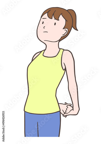 大胸筋と三角筋のストレッチをする女性