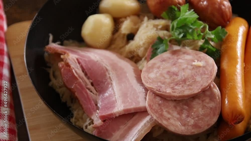 top view Choucroute garnie (French for dressed sauerkraut) is an Alsatian recipe for preparing sauerkraut with sausages and other cured meats and charcuterie, and often potatoes. top view Choucroute garnie (French for dressed sauerkraut) is an Alsatian recipe for preparing sauerkraut with sausages and other cured meats and charcuterie, and often potatoes.