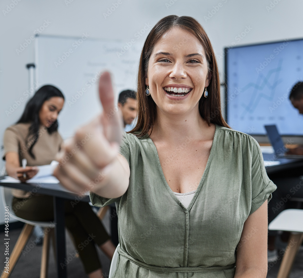 This meeting was so productive. Shot of a young businesswoman giving the thumbs up during a successful business meeting.