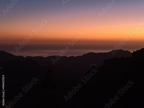 Beautiful view over the southern mountains of island Gran Canaria  Canary Islands  Spain after sunset with colorful sky above the Atlantic Ocean.