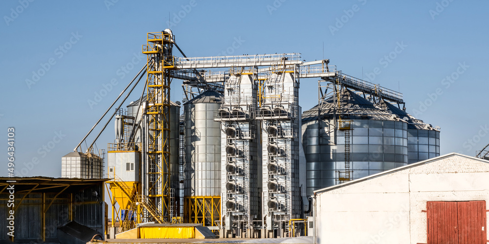 panorama view on agro silos granary elevator on agro-processing manufacturing plant for processing drying cleaning and storage of agricultural products, flour, cereals and grain. panorama view on agro silos granary elevator on agro-processing manufacturing plant for processing drying cleaning and storage of agricultural products, flour, cereals and grain.