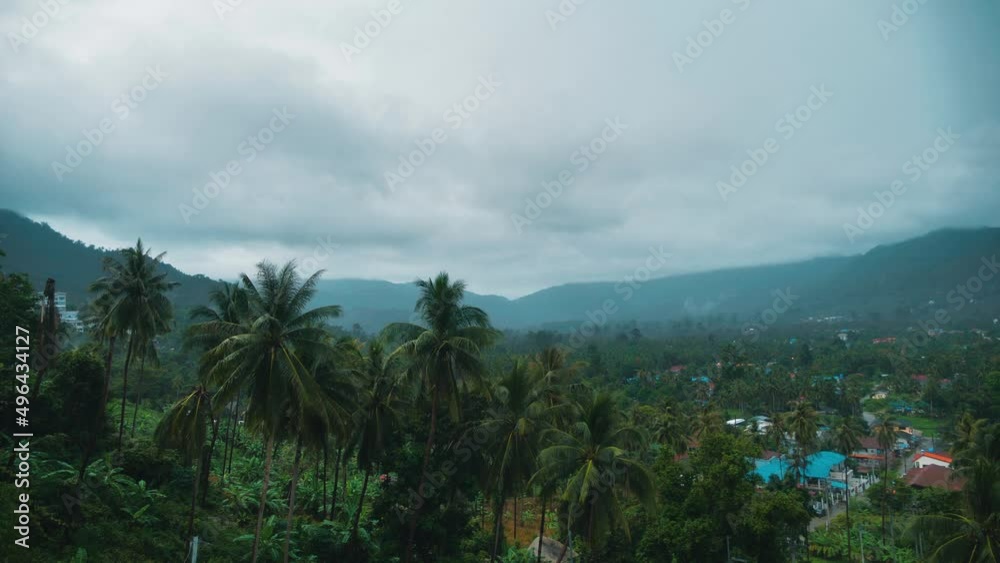 Tropic rainforest jungle with clouds move in time lapse. Rain clouds at the mountains in the tropics of the island in Ko Samui, Thailand. Timelapse 4K. Green landscape. Tropic rainforest jungle with clouds move in time lapse. Rain clouds at the mountains in the tropics of the island in Ko Samui, Thailand. Timelapse 4K. Green landscape.