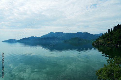 Tranquil panoramic view of the mountains in Skadar lake in Montenegro. Calm turquoise landscape background © serebryannikov