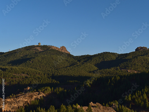 Panoramic view of the central mountains of island Gran Canaria, Canary Islands, Spain in the evening sunlight with peak Pico de las Nieves.