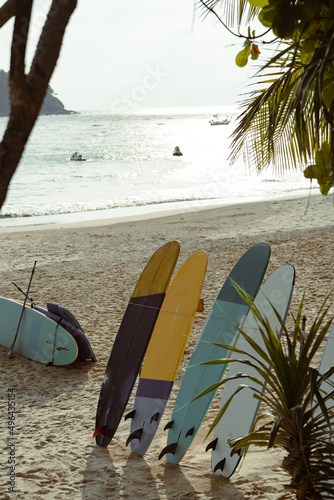 Close up surf on sea daytime. Surfboard on sand beach summer.