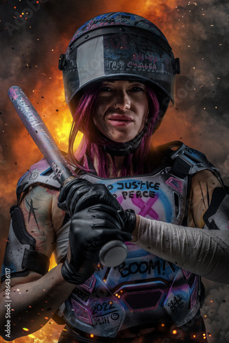 Violent woman protester dressed in painted vest holding baseball bat