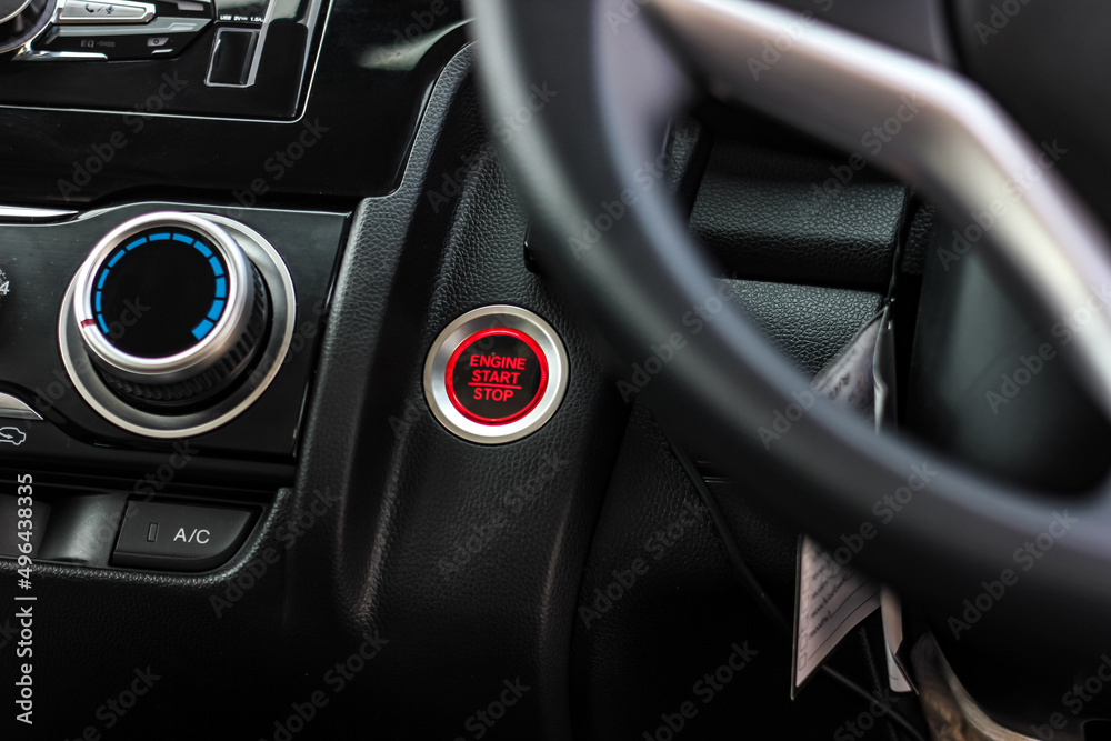 Close up engine car start button. Start stop engine modern new car button,Makes it easy to turn your auto mobile on and off. a key fob unique ,selective focus Close up engine car start button. Start stop engine modern new car button,Makes it easy to turn your auto mobile on and off. a key fob unique ,selective focus