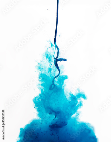 blue ink pours in and dissolves in water. Blue paint splash. Abstract background.