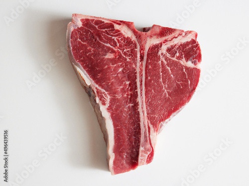 Canvas Print Isolated red tbone cut steak on white background.