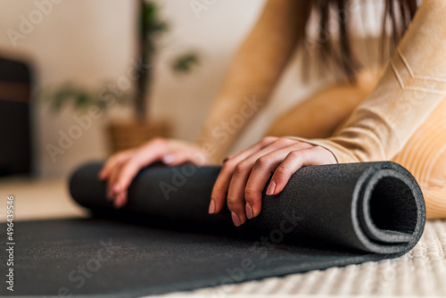 Close up shot of rolling yoga mat, starting with workout.