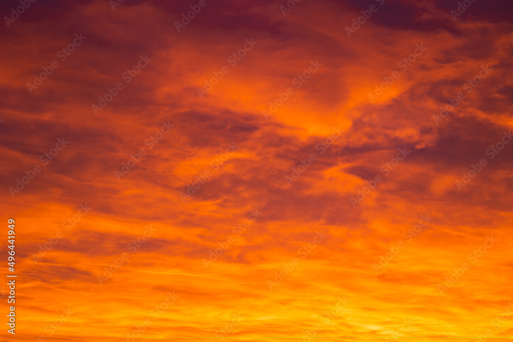 Nature background photo. Orange clouds at sunrise or sunset