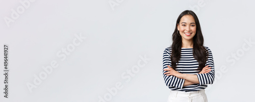 Lifestyle, people emotions and casual concept. Confident nice smiling asian woman cross arms chest confident, ready to help, listening to coworkers, taking part conversation photo