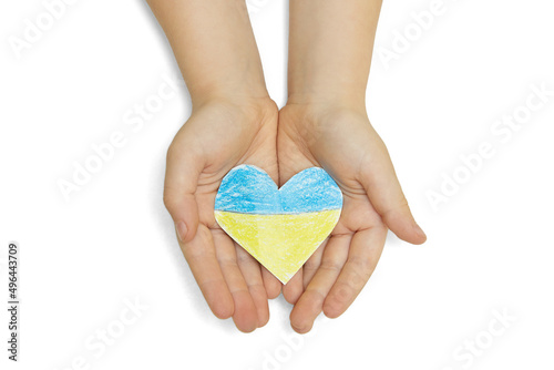 The national flag of ukraine with the coat of arms in female hands. Flat lay.