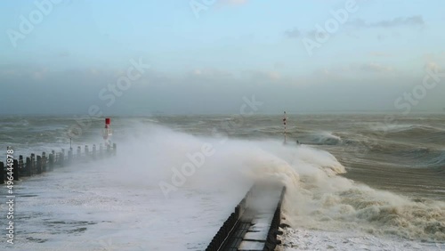 Waves overflowing above pier during storm Eunice, Vlissingen, Netherlands photo