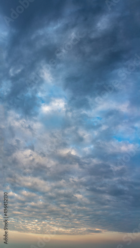 Fantastic thunderclouds at sunrise  vertical panorama