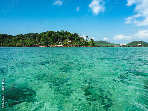 Scenic view of Koh Mak Island peaceful sea with crystal clear turquoise water and coral reef transparent against blue sky in summer. Trat, Thailand.