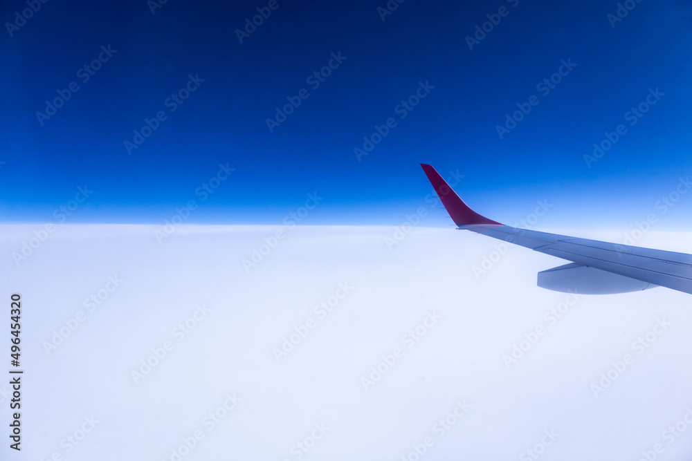 View of the wing of an airplane during a flight in the sky. View of the wing of an airplane during a flight in the sky.