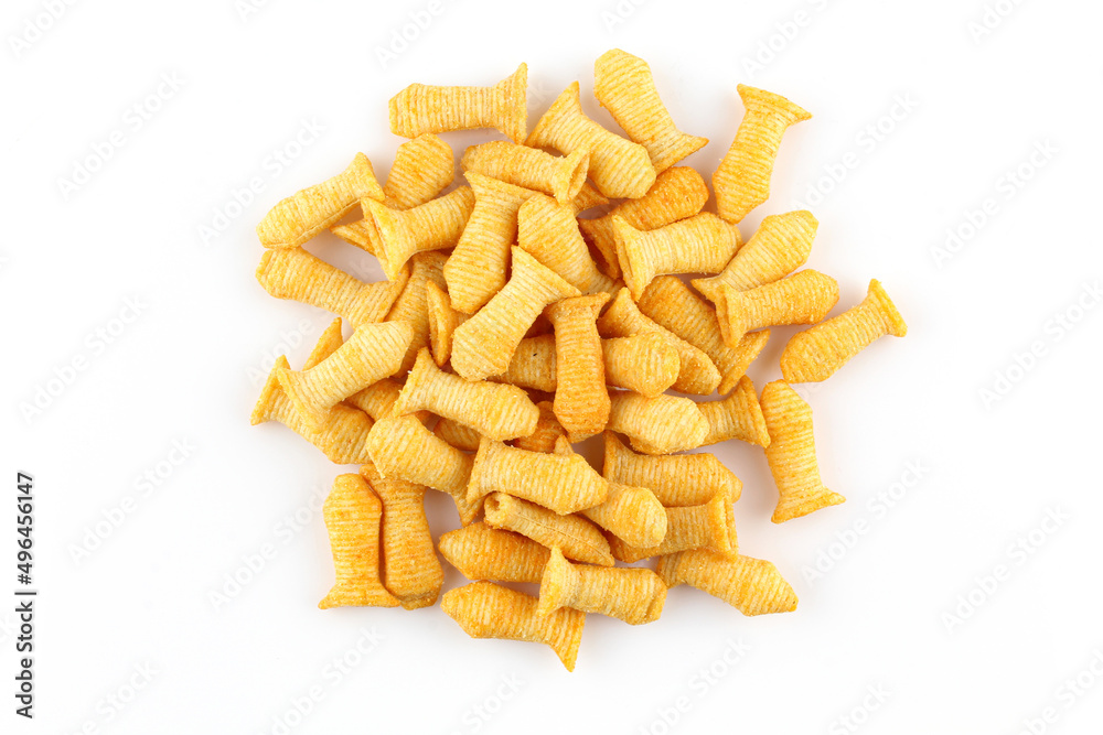 Fototapeta premium Pile of fish shaped crispy corn puffs isolated on white background