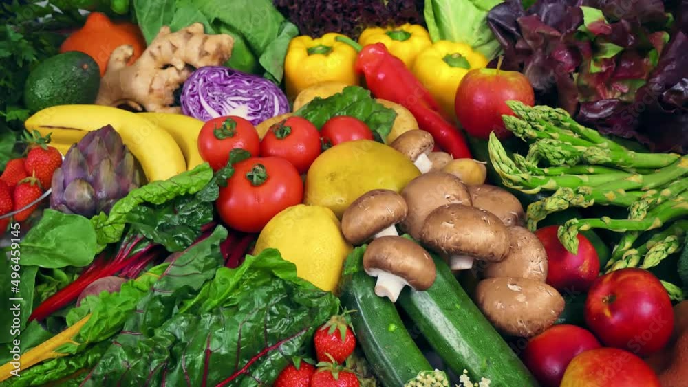 Colorful bunch of fresh vegetables and fruits with the camera moving around them. Symbol of healthy lifestyle and nutritious plant-based eating 
