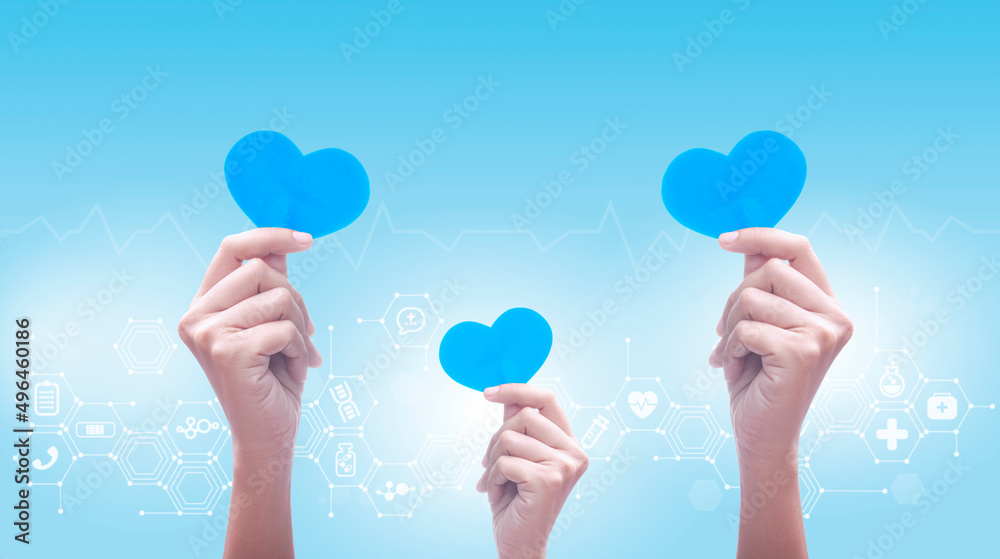 Doctor holding light blue heart shape with medical icon network connection,healthcare and medicine concept, health insurance. Doctor holding light blue heart shape with medical icon network connection,healthcare and medicine concept, health insurance.