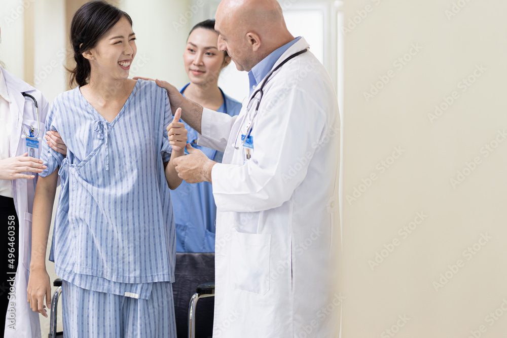 A young African girl sits for the doctor to check her health and plays with her mobile phone.